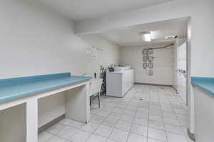 Community laundry with washer and dryer and baseboards