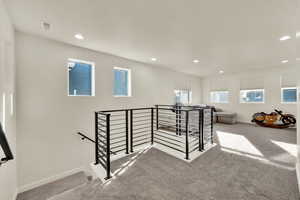 Versatile upstairs loft offering flexible living space ideal for a second lounge, office, or play area.