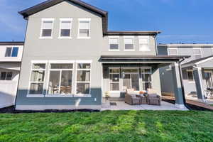 Fully landscaped backyard with automatic sprinklers, partial fencing, and a covered patio ideal for outdoor living.