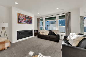 Bright and comfortable gathering area featuring recessed lighting and quality window coverings for a polished, finished feel.