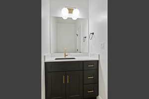 Bathroom featuring vanity and baseboards