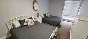 Bedroom with dark colored carpet