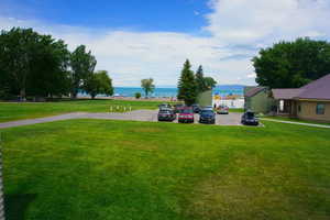 View of green lawn featuring a water view