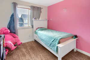 Bedroom featuring baseboards and carpet floors
