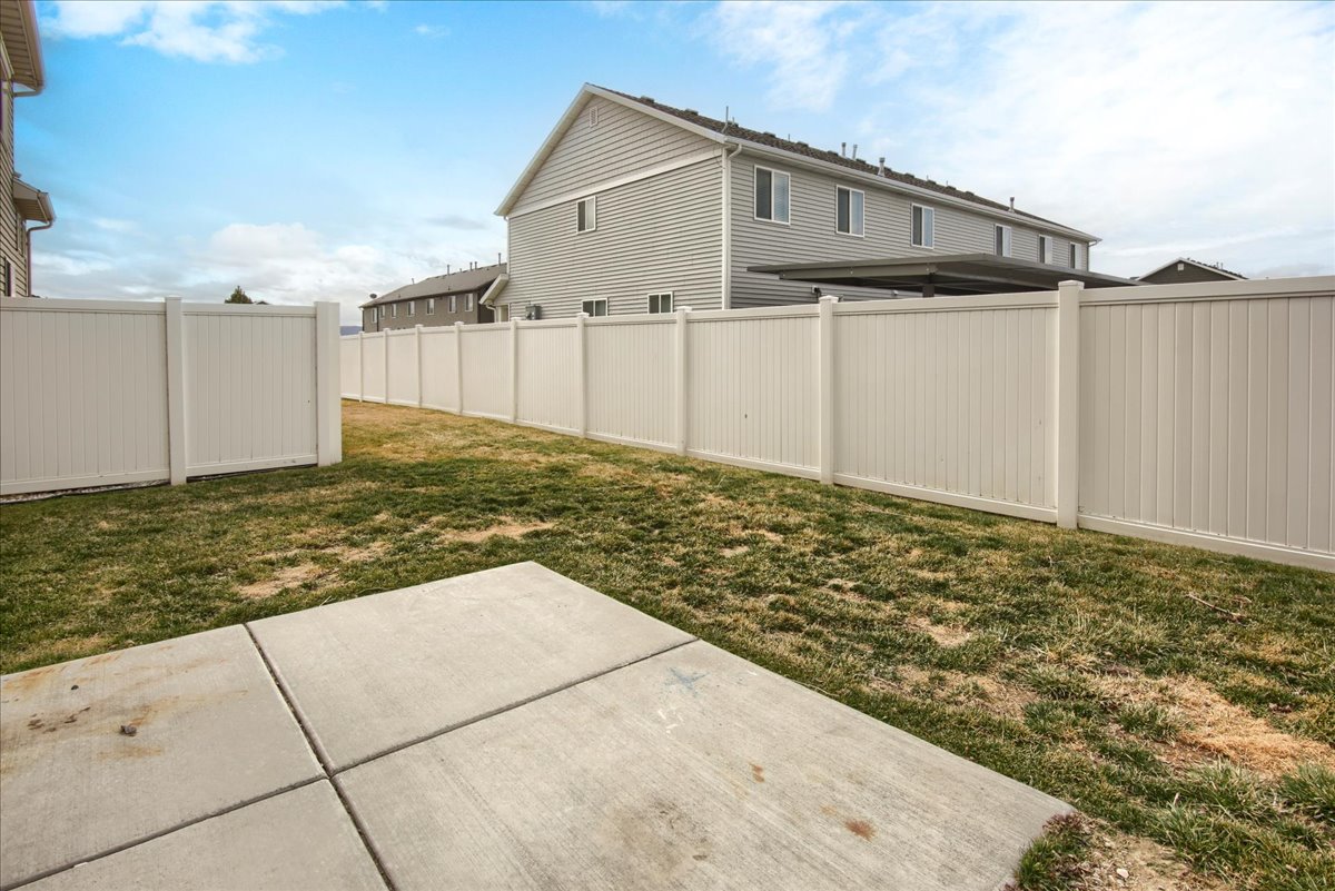 Fenced backyard featuring a patio