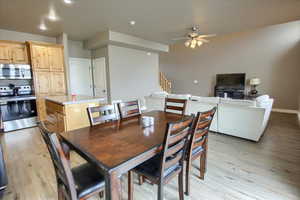 Dining area with light wood-style floors, ceiling fan, and recessed lighting