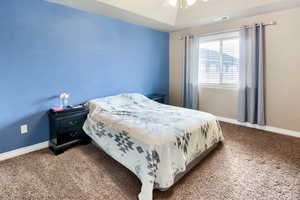 Carpeted bedroom with baseboards and ceiling fan