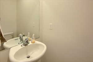 Bathroom featuring a sink and toilet