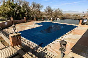 Community pool featuring a patio and a mountain view