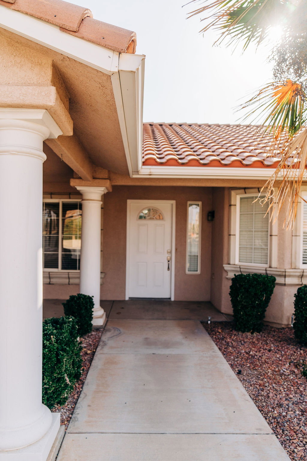 Entrance to property featuring a tiled roof and stucco siding