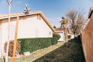 View of home's exterior with a tiled roof and stucco siding