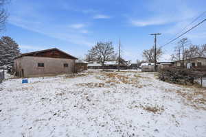 Yard covered in snow with a residential view