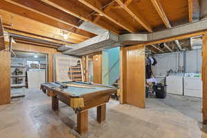 Rec room featuring separate washer and dryer, pool table, and unfinished concrete floors