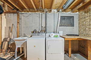 Laundry area with separate washer and dryer and unfinished concrete floors