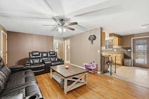 Living room featuring light wood-style flooring and a ceiling fan