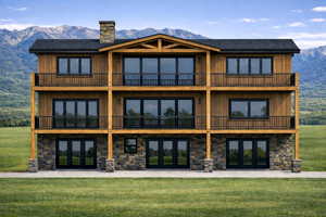 Back of property with french doors, a mountain view, stone siding, and a lawn