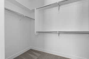 Walk in closet featuring dark carpet