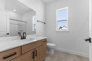 Bathroom featuring vanity and a shower
