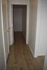Corridor featuring dark wood-style floors
