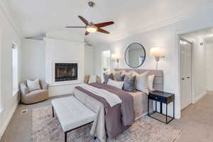 Beautiful master bedroom with fireplace and seating area