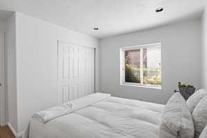 Carpeted bedroom featuring a closet and baseboards