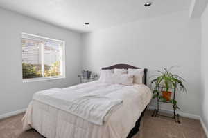 Carpeted bedroom featuring baseboards