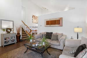 Living room with concrete floors and vaulted ceiling