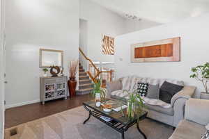Living room with lofted ceiling and dark tile patterned flooring
