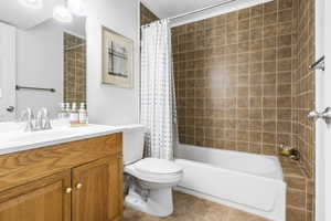 Full bath featuring vanity and shower / bath combo with shower curtain