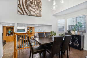 Dining area featuring plenty of natural light, a high ceiling, built in features, and a fireplace
