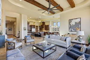 Living area featuring a ceiling fan, light tile patterned floors, recessed lighting, and a tray ceiling