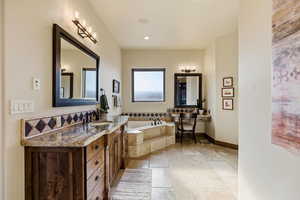 Full bath with a bath and vanity