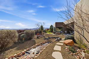 View of yard with a patio and a mountain view