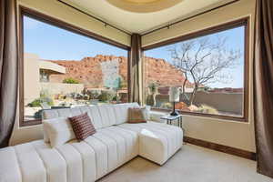 Sitting room featuring carpet and baseboards