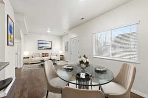 Virtual staging- Dining area featuring dark wood finished floors and a textured ceiling