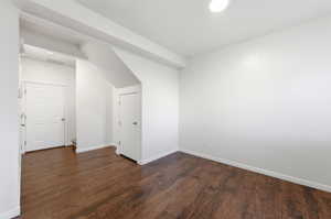 Unfurnished room featuring dark wood-style flooring