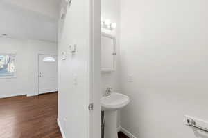 Bathroom featuring baseboards and dark wood finished floors
