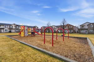 Communal playground with a yard and a residential view