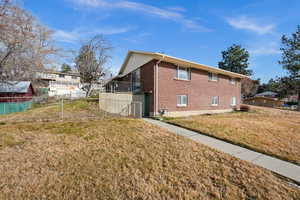View of side of property featuring brick siding and a balcony