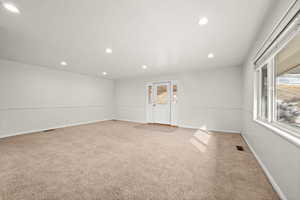Empty room featuring light carpet and recessed lighting