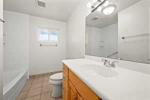 Full bathroom featuring vanity, light tile patterned floors, and tub / shower combination