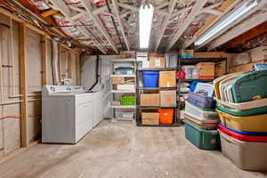 Unfinished basement featuring independent washer and dryer