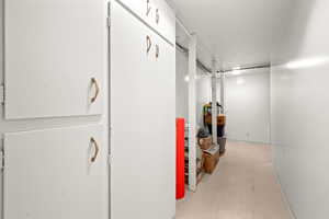 Corridor with light flooring and baseboards