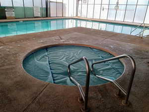 Indoor community pool with a community hot tub