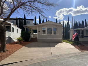 View of front of property with driveway and a porch