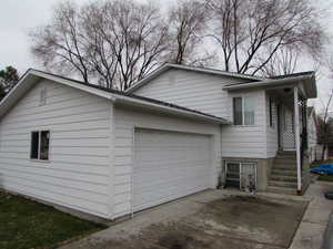 View of home's exterior with driveway and an attached garage