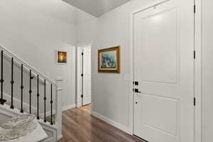 Foyer with stairway and dark wood-type flooring
