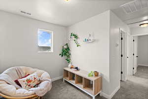 Sitting room with carpet floors and baseboards