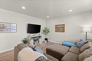 Living room featuring wood finished floors and recessed lighting