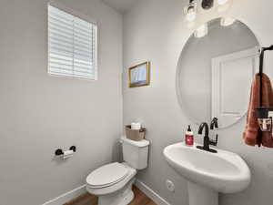 Bathroom featuring toilet and wood finished floors